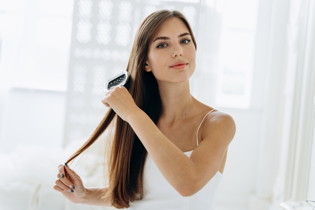 140124337 brushing hair portrait of young woman brushing st 2022 12 16 11 36 05 utc
